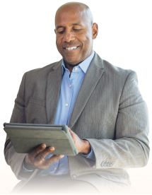 Man working on a computer, managing health and wellness services
