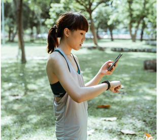 Woman looking at heur smartwatch after a run