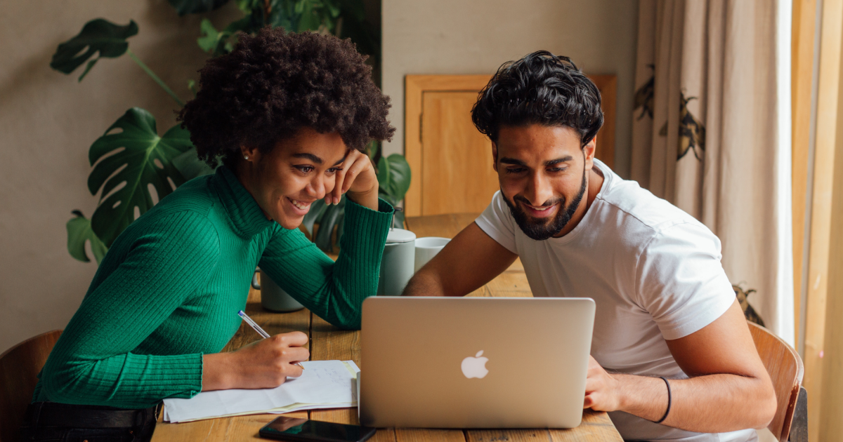 Two coworkers looking at a computer