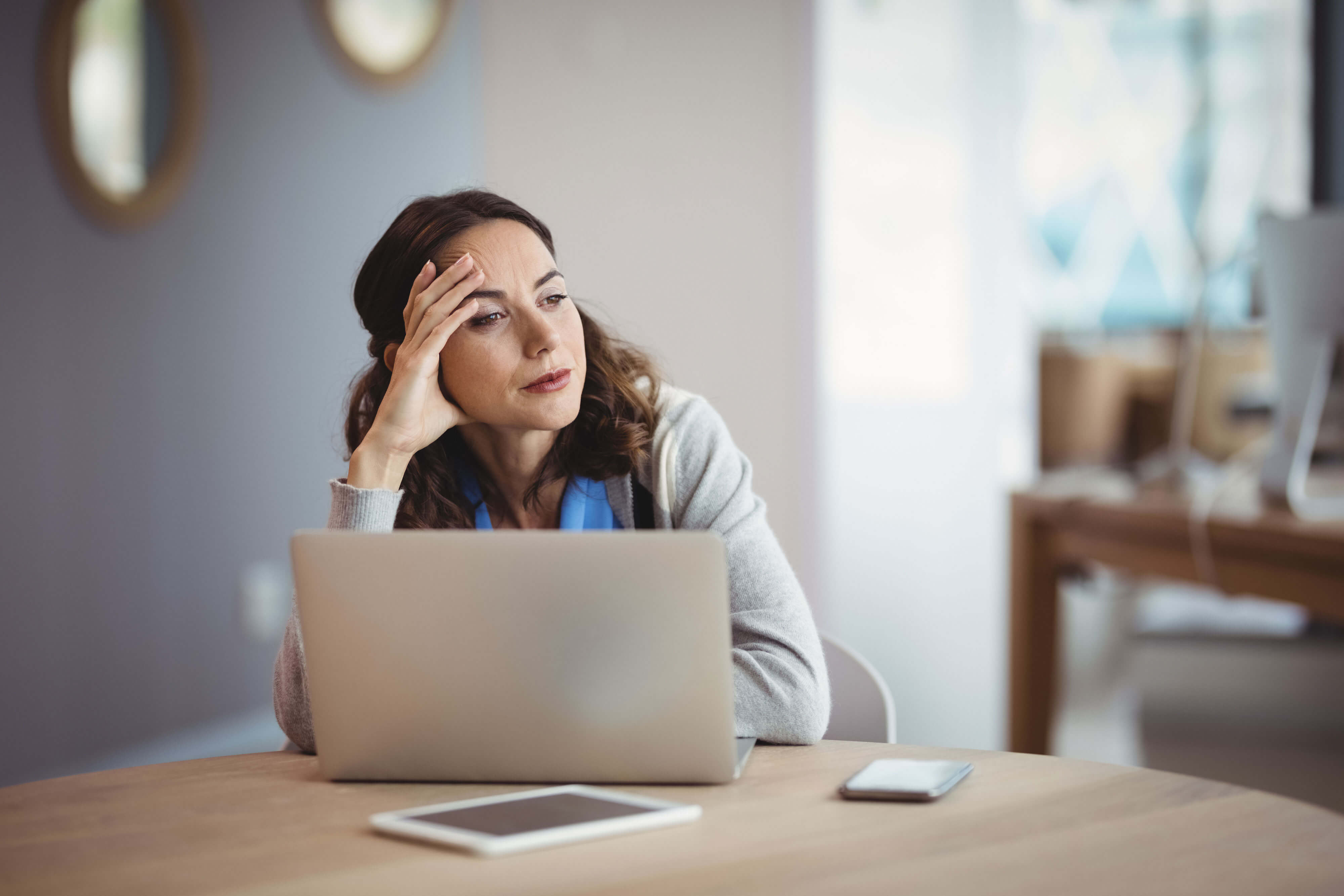 Women thinking in front of computer