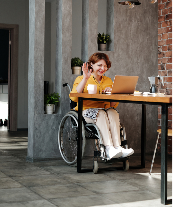 woman-in-orange-tank-top-sitting-on-black-wheelchair-4064696 1